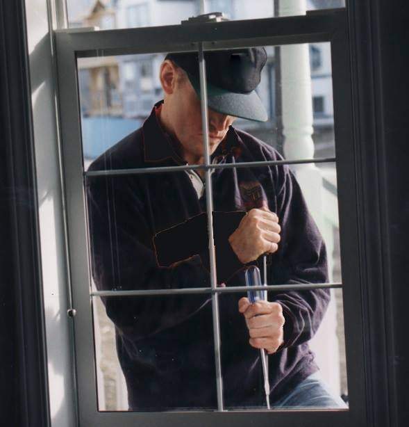 FILE: A photo of a suspect attempting to break in to a home. 