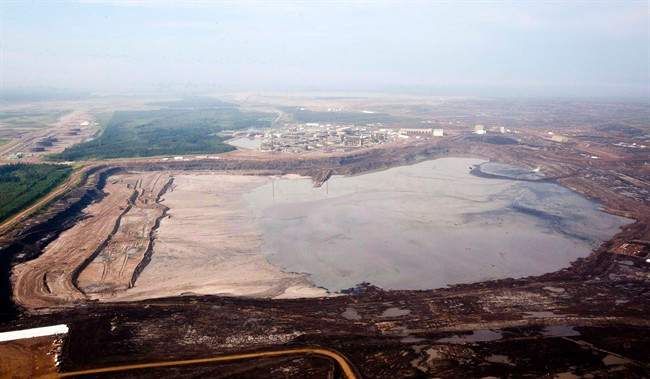 FILE: A tailings pond at the Syncrude oilsands facility is seen from a helicopter near Fort McMurray, Alta., July 10, 2012.