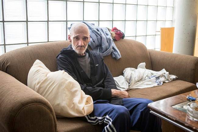 Dan Thibideau sits in his room at Toronto's Fred Victor transitional housing centre on Wednesday, July 30 , 2014. Thibideau, who has cancer, is the first patient of the PEACH (Palliative Education and Care for the Homeless) program.