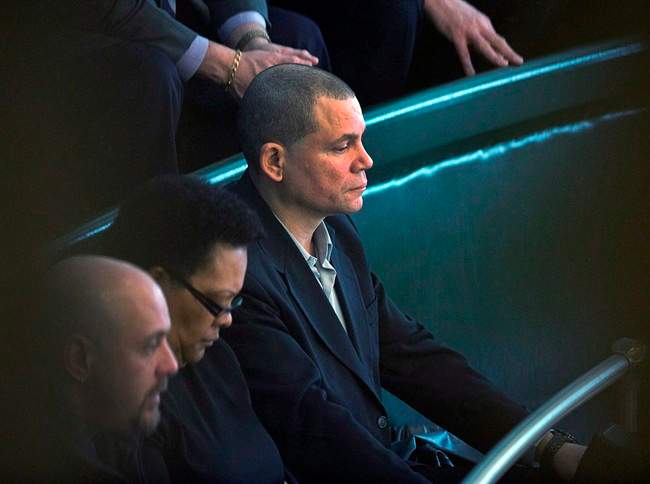 Tony Smith, right, a former resident of the Nova Scotia Home for Colored Children, listens to the throne speech in the legislature in Halifax on Tuesday. March 26, 2013. 