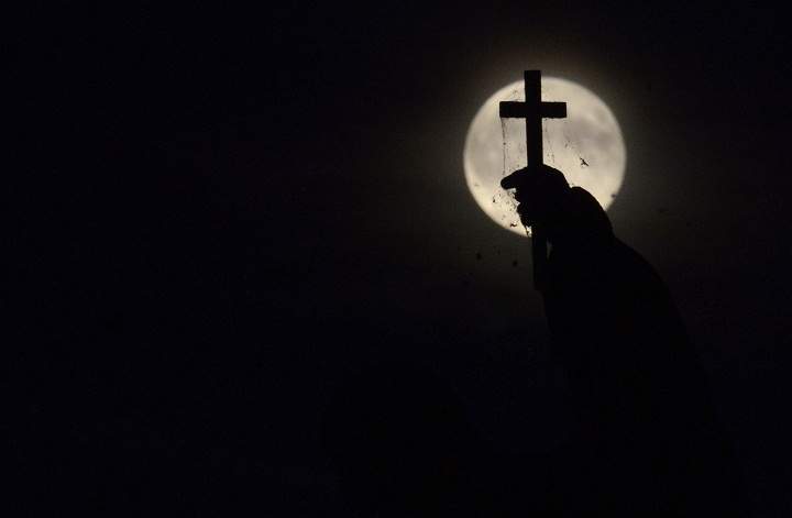The full moon nicknamed "the supermoon" rises over the statue on the Charles Bridge on August 10, 2014 in Prague.