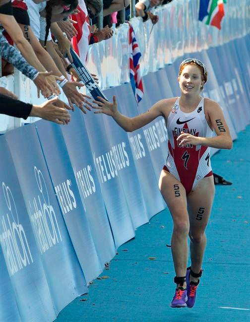 Paula Findlay of Canada is congratulated by fans as she finishes the Elite Women Championship at the ITU World Triathlon Grand Final in Edmonton, Alta., on Saturday August 30, 2014.
