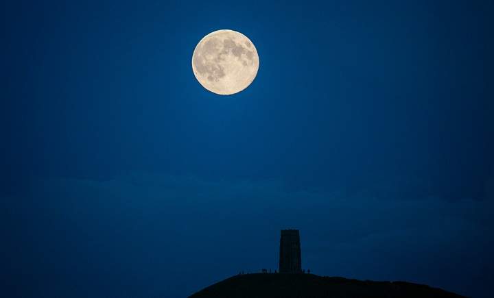 The moon rises above Glastonbury Tor on August 10, 2014 in Somerset, England.