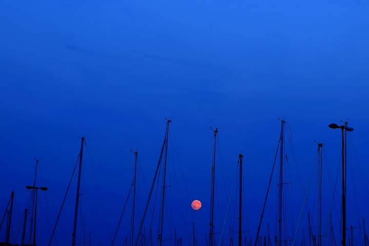 A supermoon raises over Fiskeback harbour with sailing boats, outside of the Gothenburg, Sweden, Sunday, August 10, 2014.