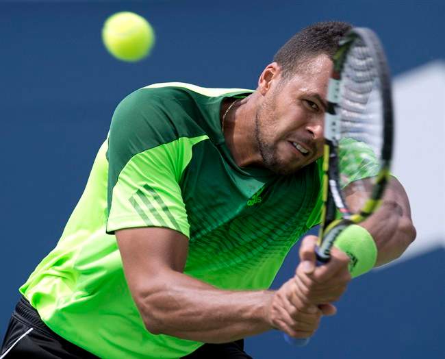 Jo-Wilfried Tsonga of France hits a backhand during win over Andy Murray of Great Britain in Rogers Cup tennis quarter-final action in Toronto on Friday August 8, 2014. THE CANADIAN PRESS/Frank Gunn.