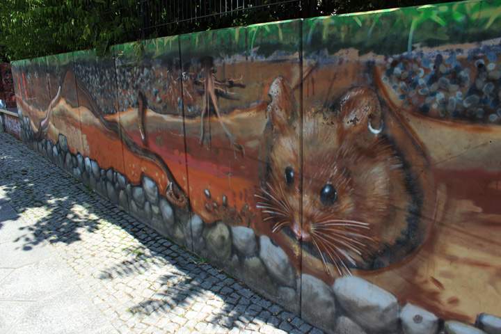 A mural along a park's wall in Friedrichshain, Berlin.