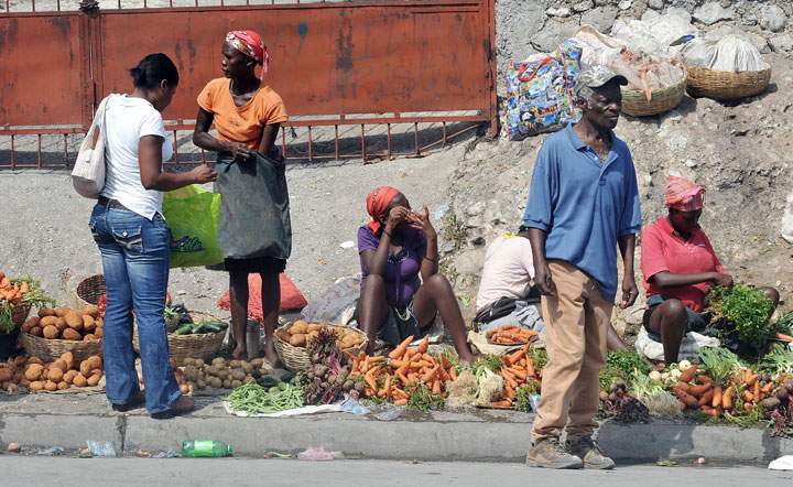 Vendors sell vegetables at an outdoor market in the 'Freres' neighborhood of Port-au-Prince.