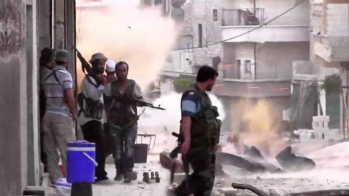 An image grab taken from AFP TV shows Syrian rebels taking position during clashes with Syrian regime forces in the Amariyeh district of the northern city of Aleppo on August 31, 2012.