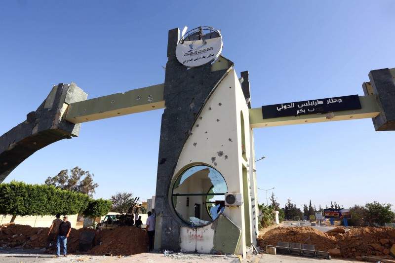 Islamist fighters in the Fajr Libya (Libyan Dawn) coalition stand at the entrance of Tripoli international airport on August 24, 2014, after capturing it from Zintan force, allies of rogue general Khalifa Haftar, following many days of clashes. AFP PHOTO/MAHMUD TURKIA.