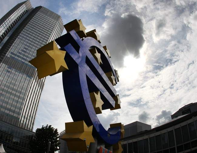 In this July 31, 2012 file photo the euro sculpture stands in front of the headquarters of the European Central Bank, ECB, in Frankfurt, Germany. 