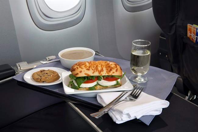 This product image provided by United Airlines shows a Caprese on Asiago Baguette sandwich, one of a variety of the airline’s new first class food options.