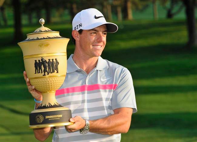 ory McIlroy poses with the championship trophy after winning the Bridgestone Invitational golf tournament, Sunday, Aug. 3, 2014, in Akron, Ohio. McIlroy won with a final round 66 to beat Sergio Garcia by two strokes. (AP Photo/Phil Long)