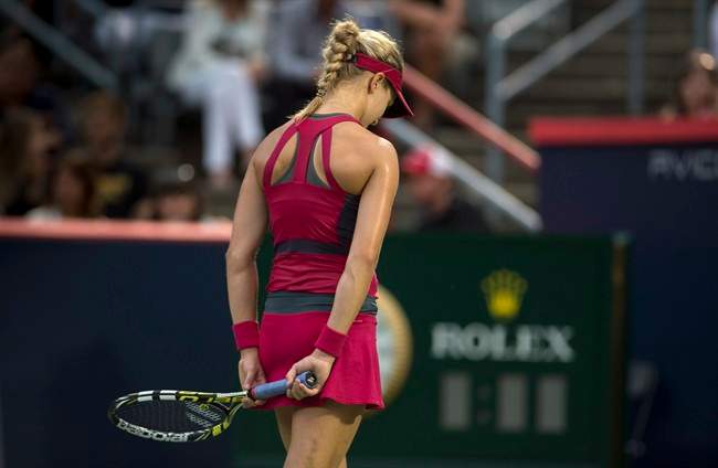 Eugenie Bouchard, from Montreal, reacts during her match against Shelby Rogers, of the United States, during first round play at the Rogers Cup tennis tournament Tuesday August 5, 2014 in Montreal. THE CANADIAN PRESS/Paul Chiasson.