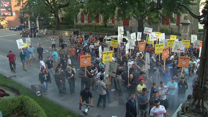 Protesters against Bill 3 storm city hall on August 18, 2014.