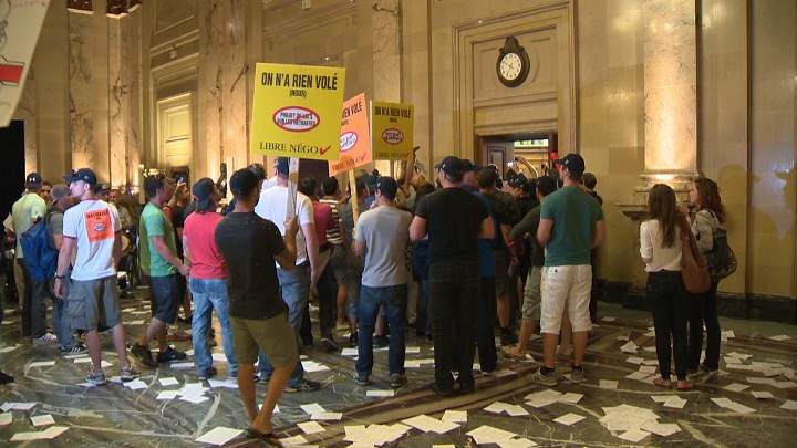 Protesters against Bill 3 storm city hall on August 18, 2014.