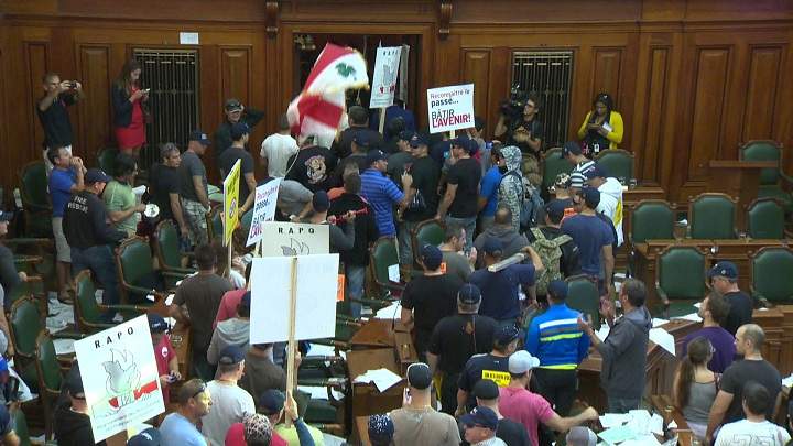 Protesters against Bill 3 storm city hall on August 18, 2014.