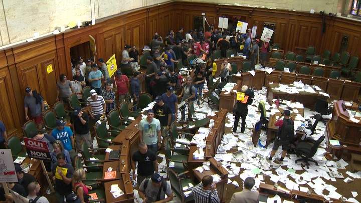 Protesters against Bill 3 storm city hall on August 18, 2014.