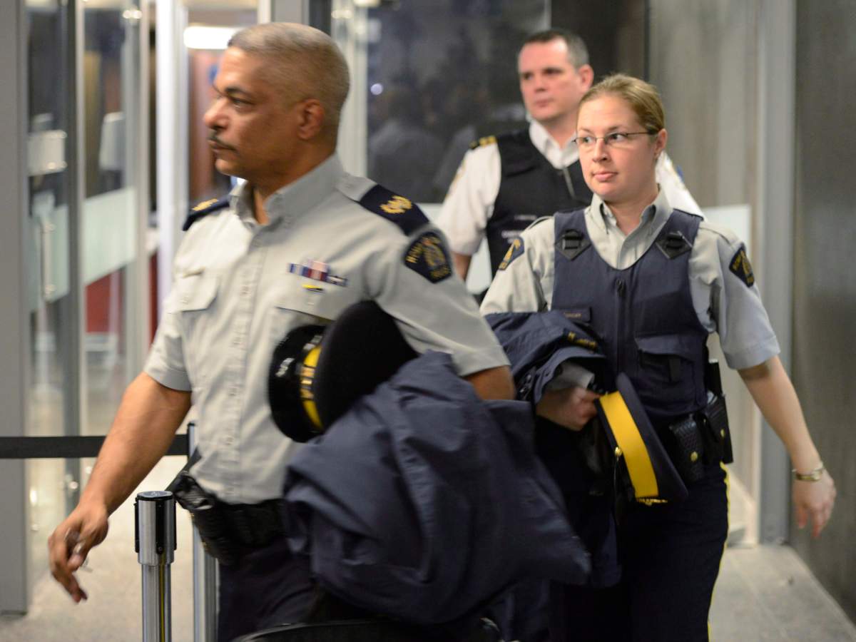 RCMP officers leave a courthouse in Montreal on Tuesday, April 23, 2013 after an appearance by terror suspect Chiheb Esseghaier, who was arrested and charged along with Raed Jaser on Monday for allegedly planning to attack a Via Rail passenger train.