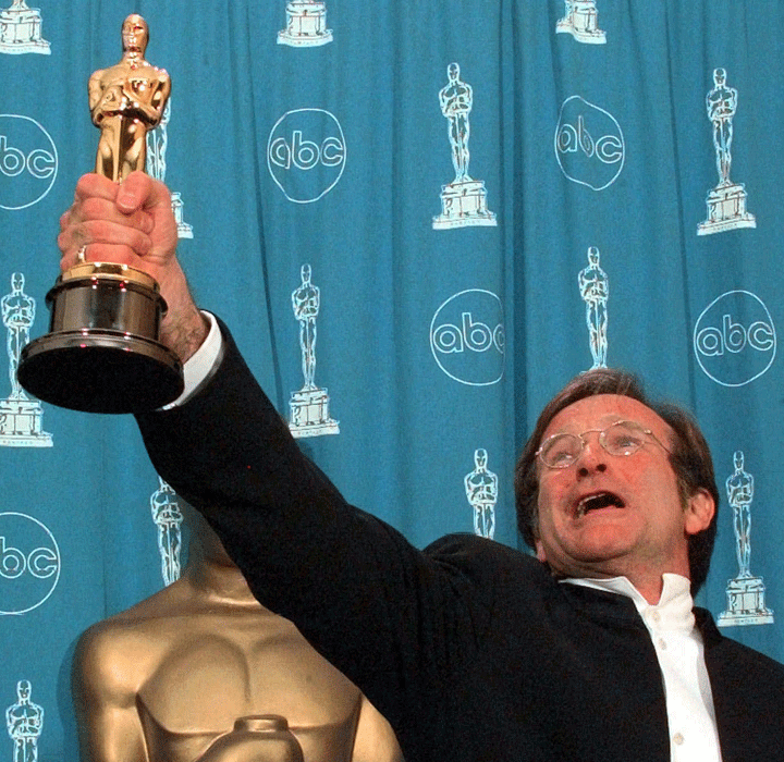 FILE – This March 23, 1998 file photo shows Robin Williams holding his Oscar high backstage at the 70th Academy Awards at the Shrine Auditorium in Los Angeles after won Best Supporting Actor for “Good Will Hunting.”
