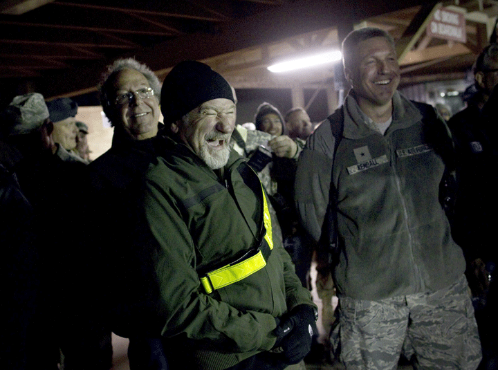 US actor Robin Williams (C) and US celebrity Lewis Black (L) laugh in the back stage during the entertaining performance of ‘Holiday Troop Visit’ by US celebrities for Christmas at boardwalk stage of the Kandahar Air Field on December 16, 2010.