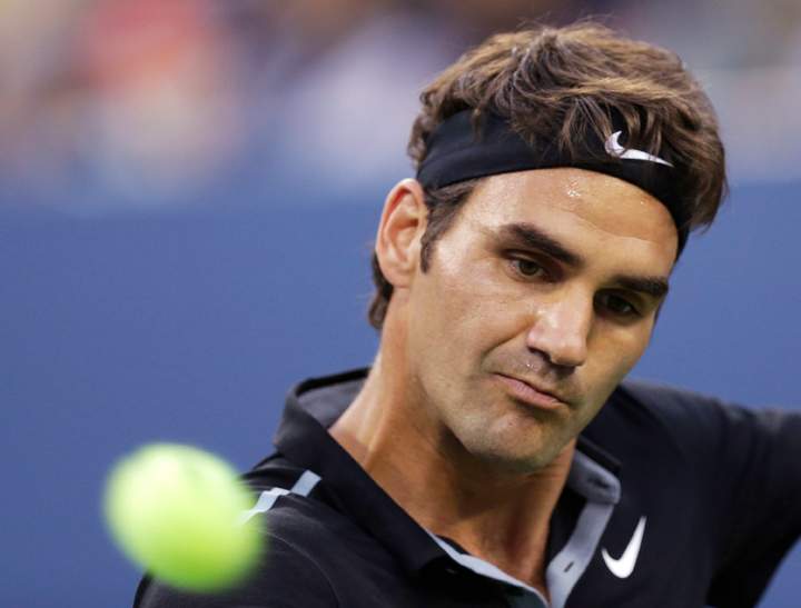 Roger Federer returns the ball to Marinko Matosevic during the first round of the U.S. Open tennis tournament Tuesday, Aug. 26, 2014, in New York.