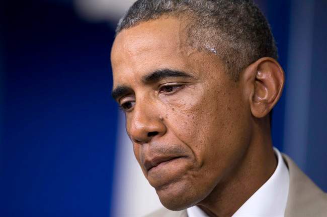 President Barack Obama pauses while speaking about the economy, Iraq, and Ukraine, Thursday, Aug. 28, 2014, in the James Brady Press Briefing Room of the White House in Washington. 