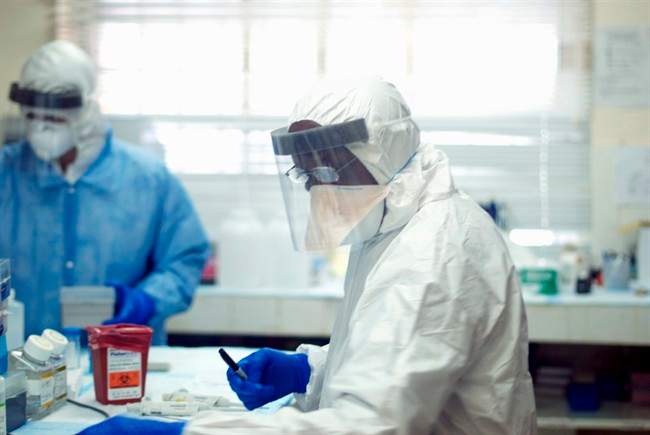This undated handout photo provided by the journal Science shows Augustine Goba, laboratory director at Kenema Government Hospital in Sierra Leone. 