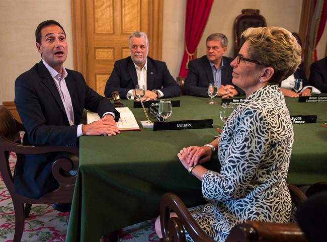 Prince Edward Island Premier Robert Ghiz, Quebec Premier Philippe Couillard, New Brunswick Premier David Alward and Ontario Premier Kathleen Wynne, left to right, attend the opening session at the Council of the Federation meeting in Charlottetown on Thursday, August 28, 2014.