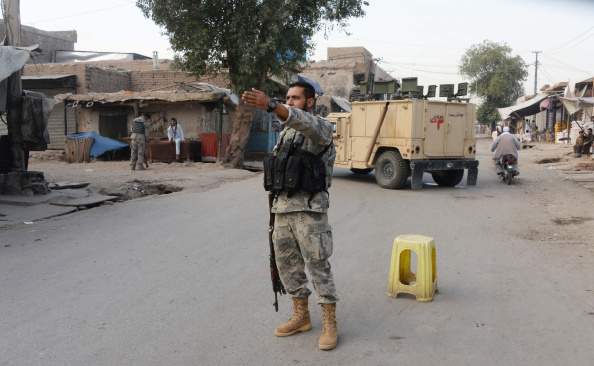 Afghan security forces stand guard around the area where Taliban militants attack to Afghan intelligence service office in Jalalabad, Afghanistan, on August 30, 2014. At least 6 killed and 51 wounded in Jalalabad, capital of Nangarhar province. 