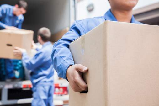 Movers unloading a moving van.