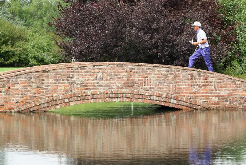 Rickie Fowler of the United States crosses a bridge on the 12th hole during the second round of the BMW Championship at the Cherry Hills Country Club on September 5, 2014 in Cherry Hills Village, Colorado. (Photo by Jamie Squire/Getty Images)