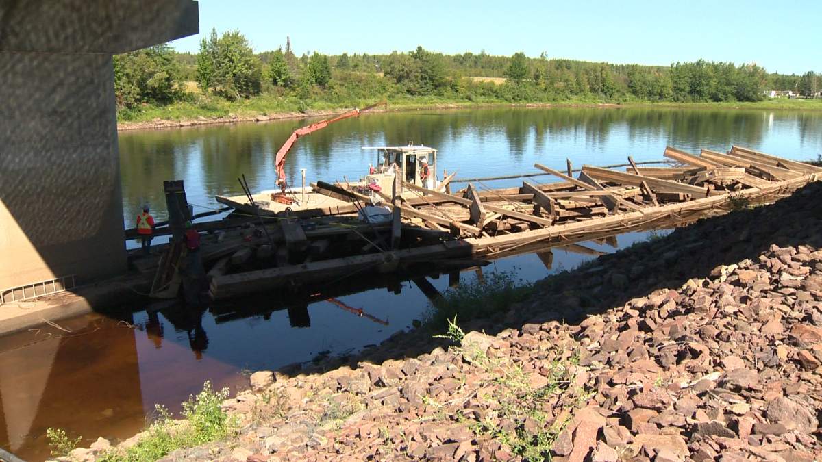 Piece by piece – crews dismantle and pluck the Cherryvale bridge from the Canaan River.
