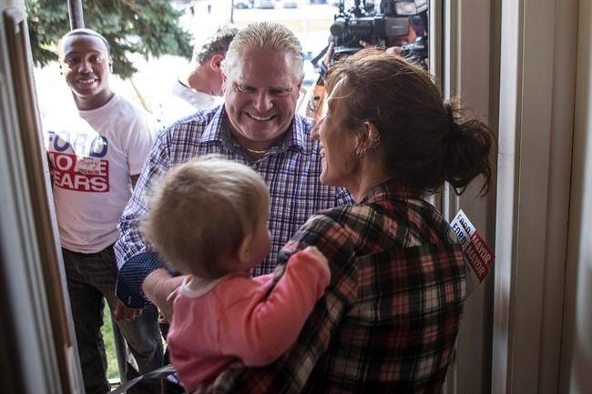 Toronto mayoral candidate Doug Ford (centre) greets Vicki Crystal and her ten-month-old grand daughter Elena as he starts his campaign by door knocking in his local Etobicoke neighbourhood of Toronto on Saturday, September 20, 2014. 