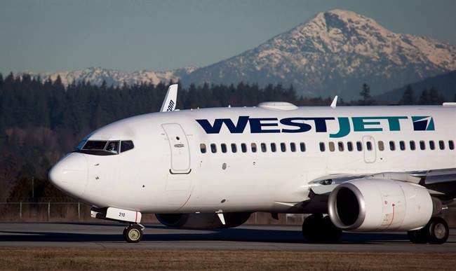 A pilot taxis a Westjet Boeing 737-700 plane to a gate after arriving at Vancouver International Airport.
