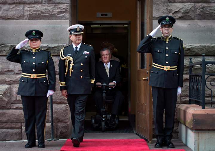 Outgoing Ontario lieutenant-governor David Onley, centre, is saluted while leaving Queen's Park in Toronto on his last full day in office on Monday, September 22, 2014.