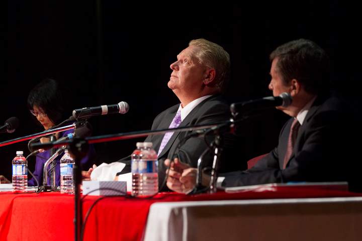 Doug Ford (centre) sits with fellow candidates Olivia Chow and John Tory as he takes part in a Toronto Mayoral Debate in Toronto on Tuesday, September 23, 2014.