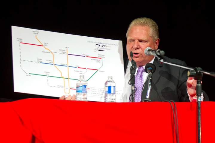 Doug Ford holds a board detailing his transit plan as he takes part in a Toronto Mayoral Debate with John Tory and Olivia Chow in Toronto on Tuesday, September 23, 2014.