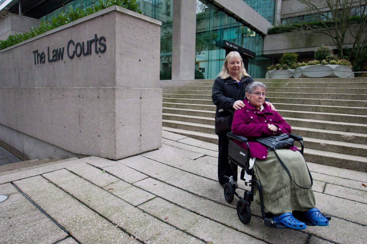 Gloria Taylor, right, is assisted by her sister Patty Ferguson as they pause for media outside British Columbia Supreme Court upon arrival in Vancouver, B.C., on December 1, 2011. THE CANADIAN PRESS/Darryl Dyck.