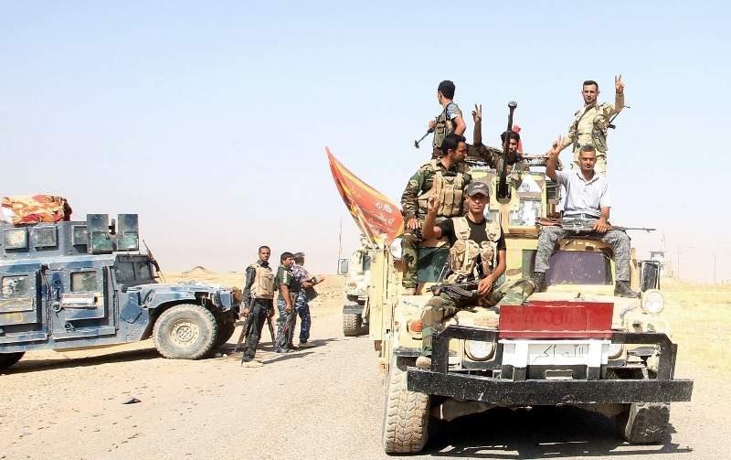 Iraqi forces arrive in the town of Amerli to deliver assistance to the Shiite Turkmen-majority town after they broke a months-long jihadist siege of the by Islamic State (IS) fighters, on September 2, 2014. AFP PHOTO/ ALI AL-SAADI.
