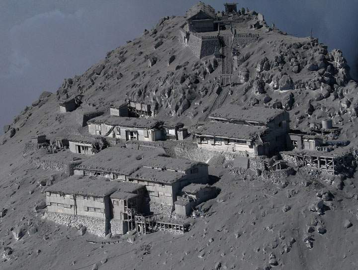 This aerial picture taken on September 28, 2014 shows mountain cottages and a Shinto shrine (above) being covered with volcanic ash on the top of Mount Ontake at Nagano prefecture, one day after Japan’s volcano Ontake erupted in central Japan, which straddling Nagano and Gifu prefecture.