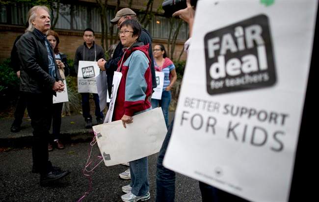 Former British Columbia Teacher Federation (BCTF) President Jim Iker is seen outside the Britannia Secondary and Elementary Schools in Vancouver, Tuesday, Sept. 2, 2014, during the last BCTF strike.
