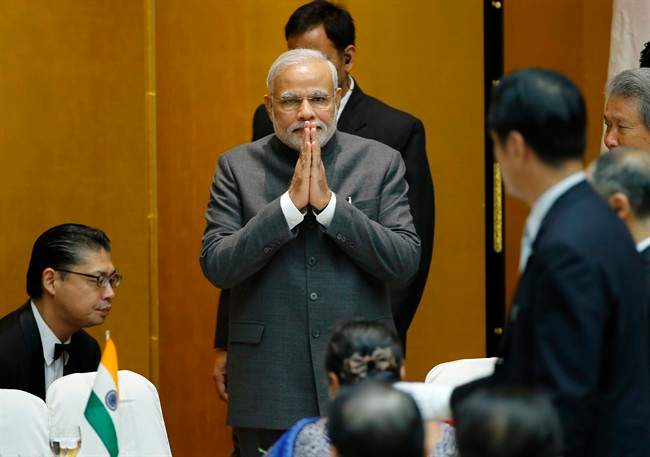 Indian Prime Minister Narendra Modi greets business leaders upon his arrival at the hall at the Japan Business Federation for luncheon in Tokyo Monday, Sept. 1, 2014. 