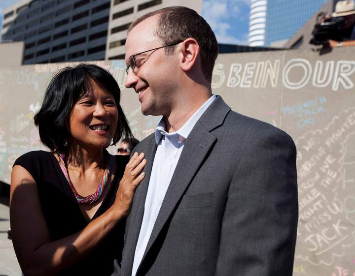 Olivia Chow, left, stands with her stepson Toronto Councillor Mike Layton, right, during a memorial marking the one year anniversary of the passing of her husband Federal NDP Leader Jack Layton in Toronto on Wednesday, August 22, 2012.
