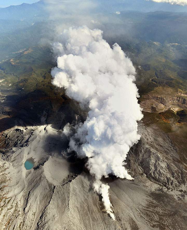 Volcanic gases and ash billow from the peak crater of Mount Ontake in central Japan Tuesday afternoon, Sept. 30, 2014.