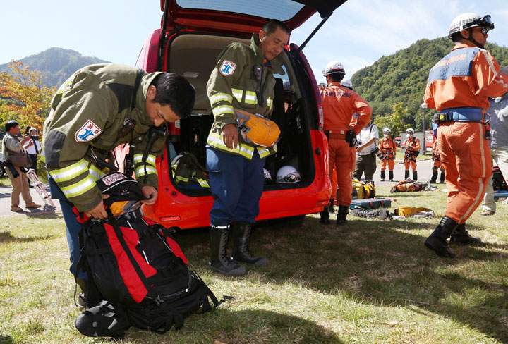 Rescue workers put their gear away as rescue operations on Japanese volcano Mount Ontake are halted for the day on September 30, 2014, in Nagano prefecture, central Japan. Helicopters were ordered to remain on the ground while troops, firefighters and police were stood down for the day, having done no real searching since the operation was suspended because of rocketing levels of toxic gas near the still-fragile peak.