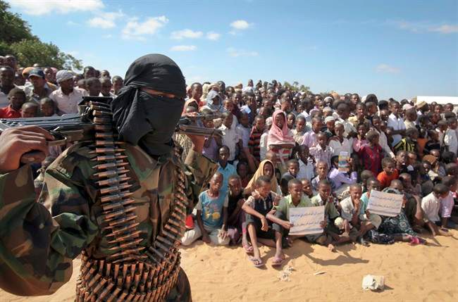 In this Feb. 13, 2012 file photo, an armed member of the militant group al-Shabab attends a rally in support of the merger of the Somali militant group al-Shabab with al-Qaida, on the outskirts of Mogadishu, Somalia. 