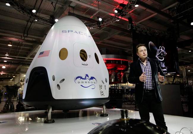 Elon Musk, CEO and CTO of SpaceX, introduces the SpaceX Dragon V2 spaceship — designed to ferry astronauts to the space station — at the SpaceX headquarters in Hawthorne, Calif.