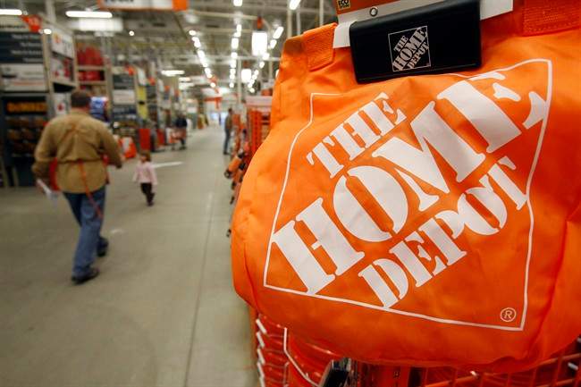 In this Feb. 22, 2010 file photo, shoppers walk through the aisles at the Home Depot store in Williston, Vt. 