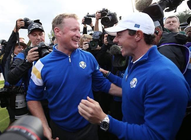 Europe’s Jamie Donaldson, left, and Rory McIlroy celebrate winning the 2014 Ryder Cup golf tournament at Gleneagles, Scotland, Sunday, Sept. 28, 2014. (AP Photo/Peter Morrison).