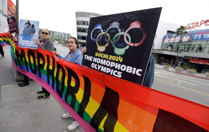 Demonstrators from a coalition of gay rights organizations, religious and political groups protest the treatment of gays in Russia, whose coastal city of Sochi hosts the 22nd Olympic Winter Games, outside the final stop of the "Road to Sochi," a traveling exhibit hosted by the U.S. Olympic Committee, at LALive in downtown Los Angeles Friday, Feb. 7, 2014. 
